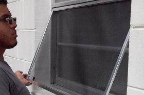 Man Installing a Window Screen